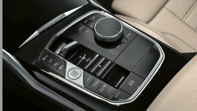 iDrive-Controller und Gangwahlschalter in der Mittelkonsole des BMW 3er iDrive-Controller und Gangwahlschalter in der Mittelkonsole des BMW 3er Touring neben heller Polsterung.